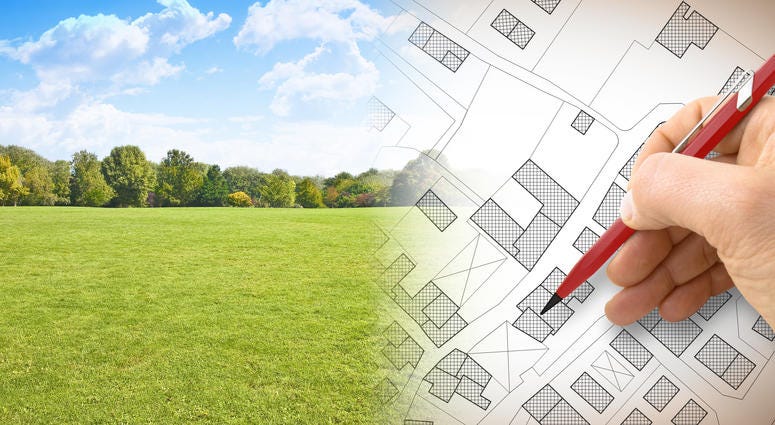 Construction plans- concept image with hand drawing and green land
