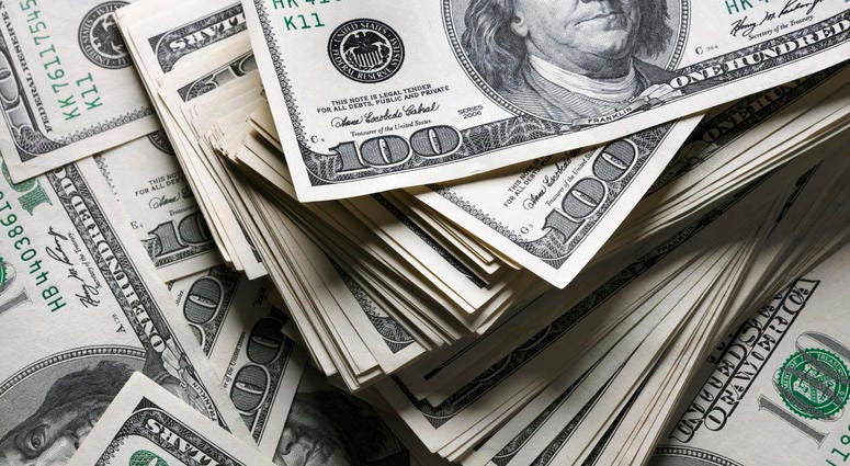 stack of one hundred dollars notes on dollars background