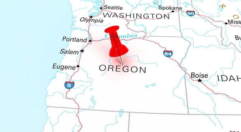 Red thumbtack over Oregon state USA map