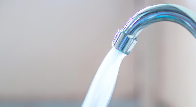 close up water running from faucet