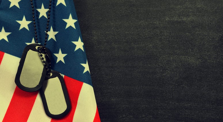 Close up of american flag and soldiers tags