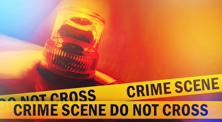 Crime scene do not cross yellow tape and orange flashing and revolving light