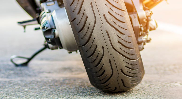 Rear wheel of sports motorcycle on road
