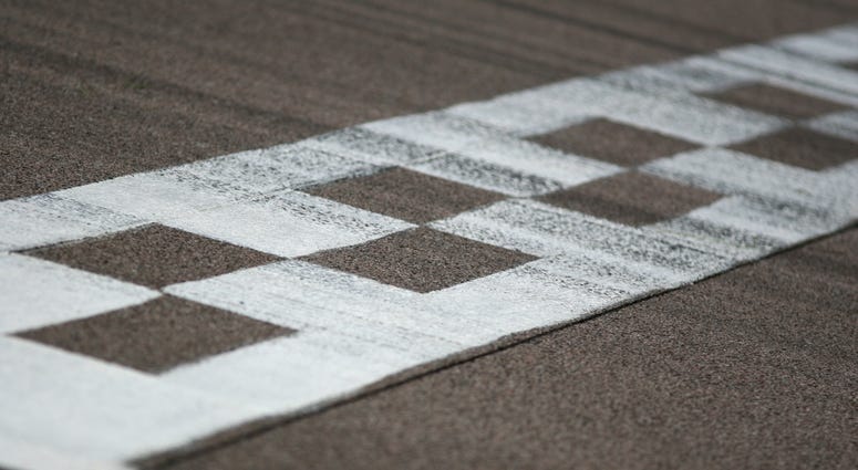 The painted start/finish line across a racetrack
