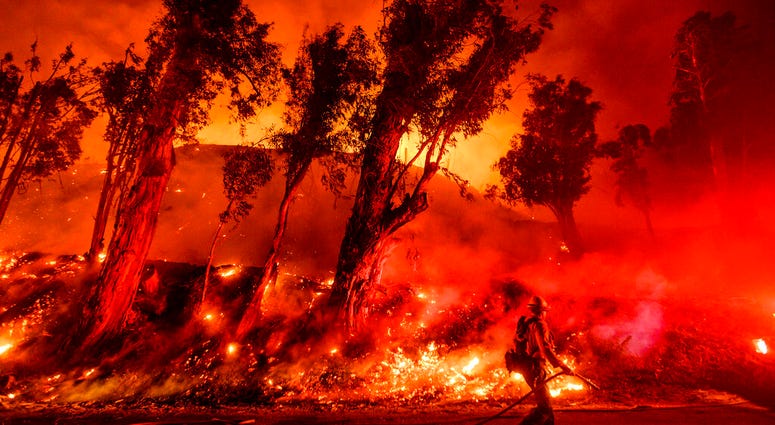 Flames from a backfire consume a hillside as firefighters battle the Maria Fire in Santa Paula, Calif. The decade that just ended was by far the hottest ever measured on Earth, capped off by the second-warmest year on record, NASA and the National Oceanic