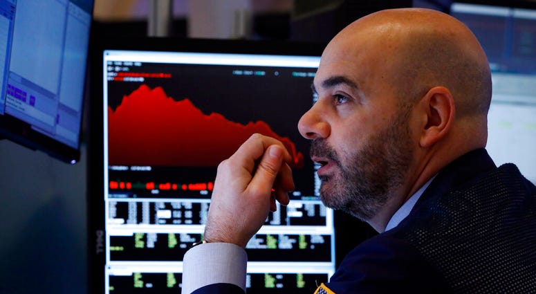 Trader Fred DeMarco works on the floor of the New York Stock Exchange, Friday, Feb. 28, 2020. Global stock markets are falling further on spreading virus fears.