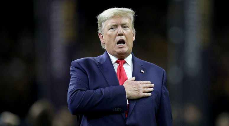 U.S. President Donald Trump stands for the national anthem prior to the College Football Playoff National Championship game between the Clemson Tigers and the LSU Tigers at Mercedes Benz Superdome on January 13, 2020 in New Orleans, Louisiana. (
