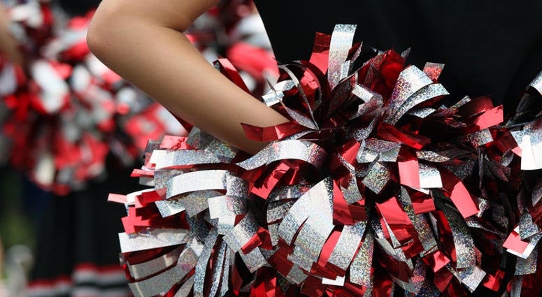 young cheerleader with red silver & black pompom