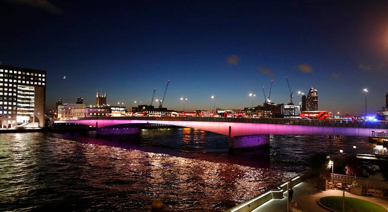Abandoned buses and other vehicles are parked after an incident on London Bridge in London, Friday, Nov. 29, 2019.