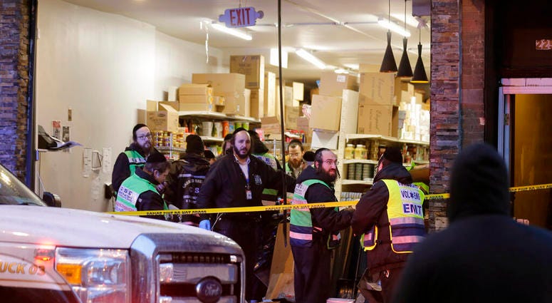 Emergency responders work at a kosher supermarket, the site of a shooting in Jersey City, N.J., Wednesday, Dec. 11, 2019.