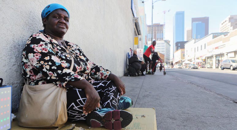 Margaret, who has been homeless since 2016, sits on the sidewalk in Skid Row on September 17, 2019 in Los Angeles, California.