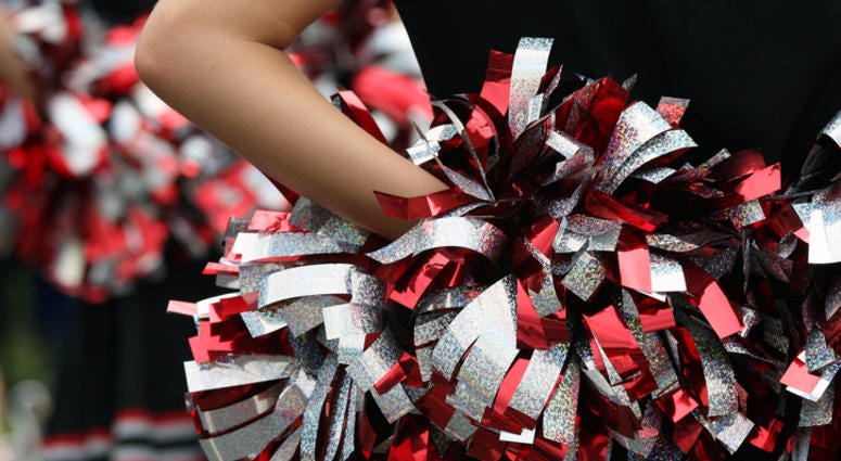 young cheerleader with red silver & black pompom