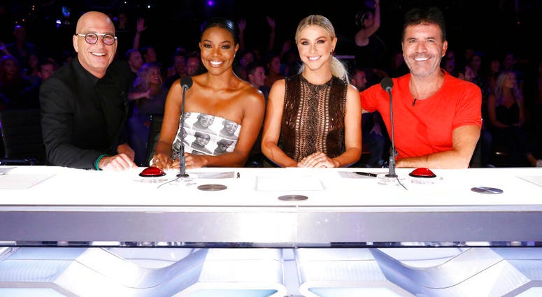 This image released by NBC shows celebrity judges, from left, Howie Mandel, Gabrielle Union, Julianne Hough, Simon Cowell on the set of "America's Got Talent," in Los Angeles.