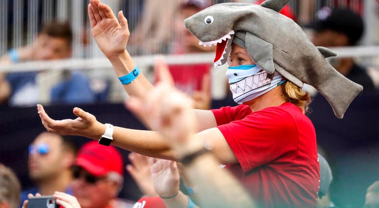In this Sept. 29, 2019, file photo, a fan wears a shark hat as Washington Nationals' Gerardo Parra comes up to bat in the eighth inning of a baseball game against the Cleveland Indians at Nationals Park in Washington.
