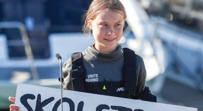 Climate activist Greta Thunberg holds a "Fridays for Future" banner in Lisbon, Tuesday, Dec 3, 2019.