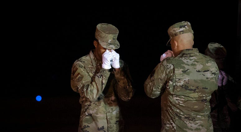 An Air Force carry team pays respect after moving a transfer cases containing the remains of Ensign Cameron Joshua Kaleb Watson, Seaman Mohammed Sameh Haitham and Seaman Apprentice Cameron Scott Walters, Sunday, Dec. 8, 2019, at Dover Air Force Base, Del.