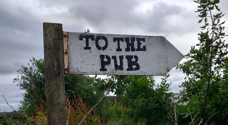 A sign pointing the way to the pub