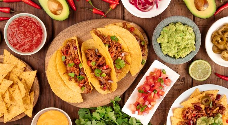 A plate of tacos and condiments