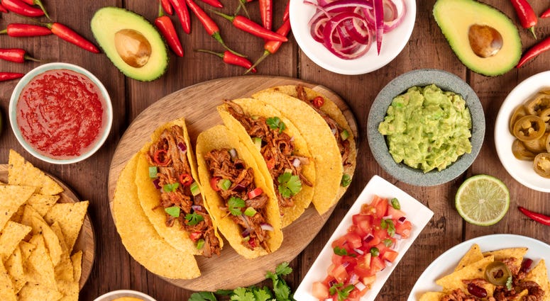 A plate of tacos and condiments