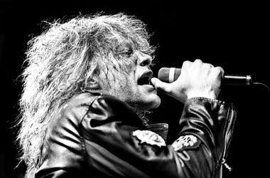Jon Bon Jovi is performing one of Bon Jovi's hits during their \"American Brotherhood\" tour for a sold-out crowd of more than 12,000 fans at Middle Tennessee State University's Murphy Center Feb. 20, 1989. 89then02 056