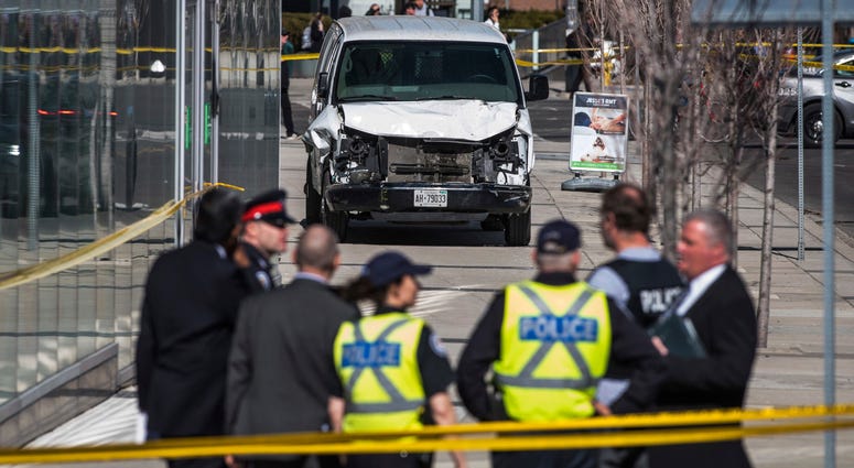 toronto Van Police are seen near a damaged van after a van mounted a sidewalk crashing into pedestrians in Toronto on Monday, April 23, 2018. The van apparently jumped a curb Monday in a busy intersection in Toronto and struck the pedestrians and fled the scene befor