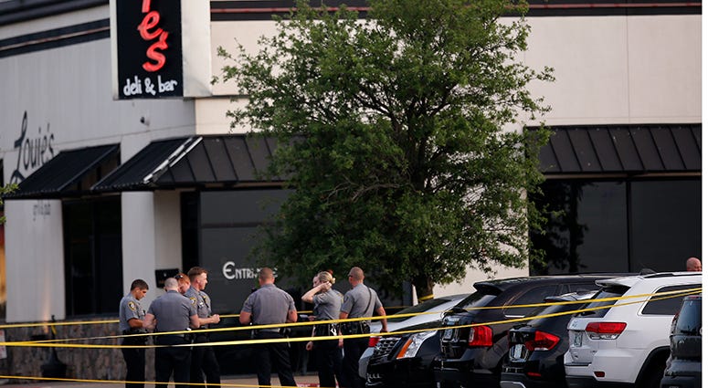 Police officers stand at the scene of a shooting on the east side of Lake Hefner in Oklahoma City, Thursday, May 24, 2018. Police officers stand at the scene of a shooting on the east side of Lake Hefner in Oklahoma City, Thursday, May 24, 2018.