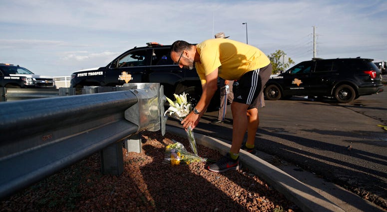 A man leaves flowers near the scene of a mass shooting at a shopping complex Sunday, Aug. 4, 2019, in El Paso, Texas. A man leaves flowers near the scene of a mass shooting at a shopping complex Sunday, Aug. 4, 2019, in El Paso, Texas.