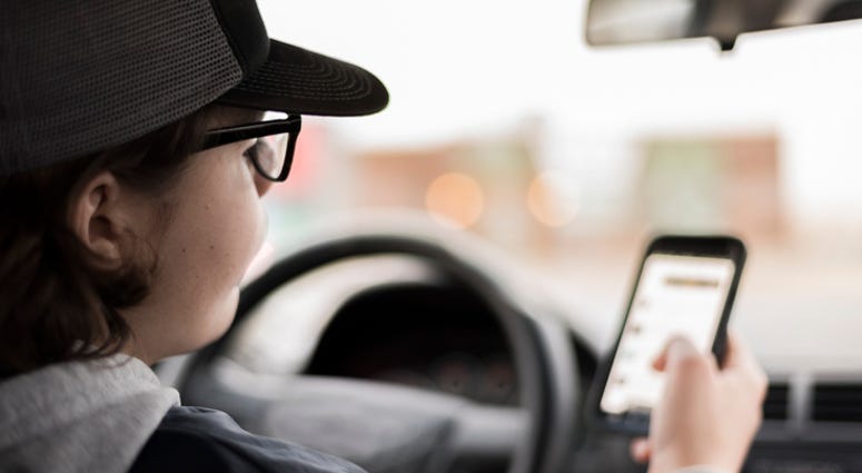 Teen Driver Looking At Mobile Phone Teen Driver Looking At Mobile Phone