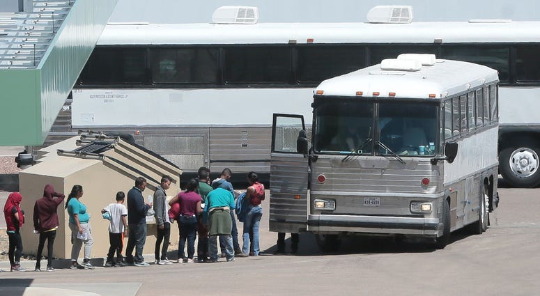 Border Holding Facility Migrants are loaded onto a bus at the Border Patrol Headquarters on Hondo Pass in El Paso
