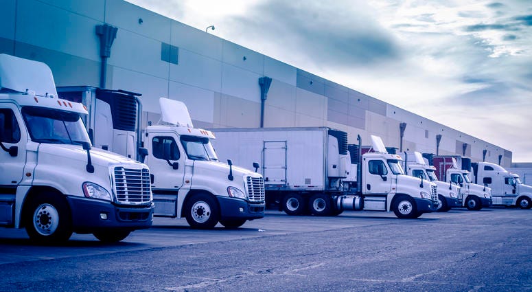 Trucks loading unloading at warehouse Trucks loading unloading at warehouse
