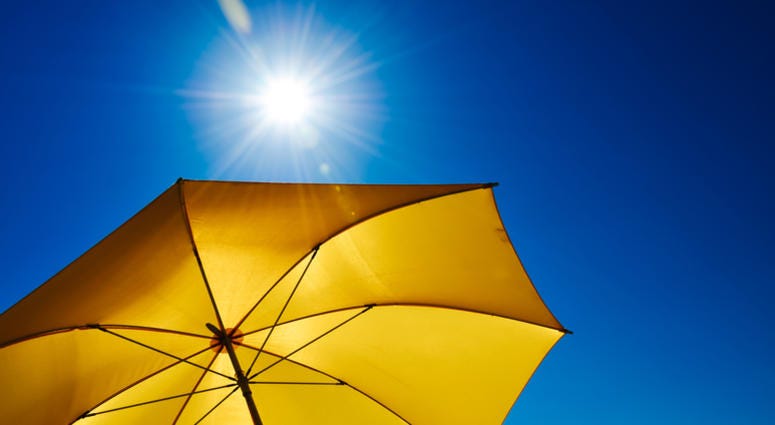 Yellow Umbrella With Bright Sun And Blue Sky Yellow Umbrella With Bright Sun And Blue Sky