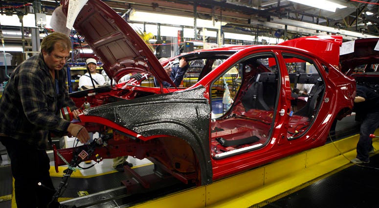 Workers assemble a preproduction Dodge Dart Workers assemble a preproduction Dodge Dart