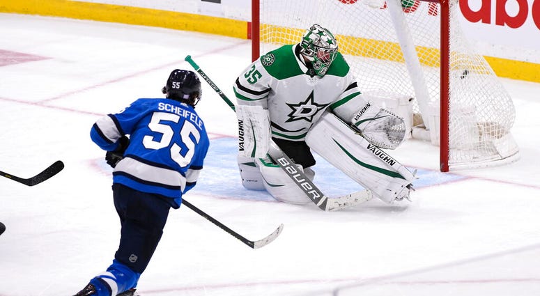 Winnipeg Jets' Mark Scheifele (55) scores the winning goal in overtime against Dallas Stars goaltender Anton Khudobin Winnipeg Jets' Mark Scheifele (55) scores the winning goal in overtime against Dallas Stars goaltender Anton Khudobin