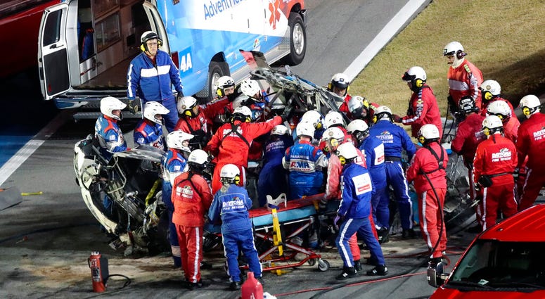 Rescue workers remove Ryan Newman from his car after he was involved in a wreck on the last lap of the NASCAR Daytona 500 Rescue workers remove Ryan Newman from his car after he was involved in a wreck on the last lap of the NASCAR Daytona 500