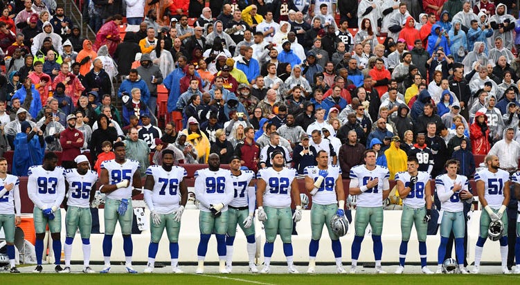 Dallas Cowboys players stand for the national anthem against the Washington Redskins before the game at FedEx Field. Dallas Cowboys players stand for the national anthem against the Washington Redskins before the game at FedEx Field.