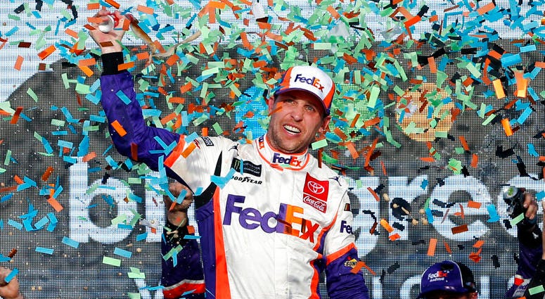 Denny Hamlin celebrates in Victory Lane after winning the NASCAR Cup Series auto race Denny Hamlin celebrates in Victory Lane after winning the NASCAR Cup Series auto race