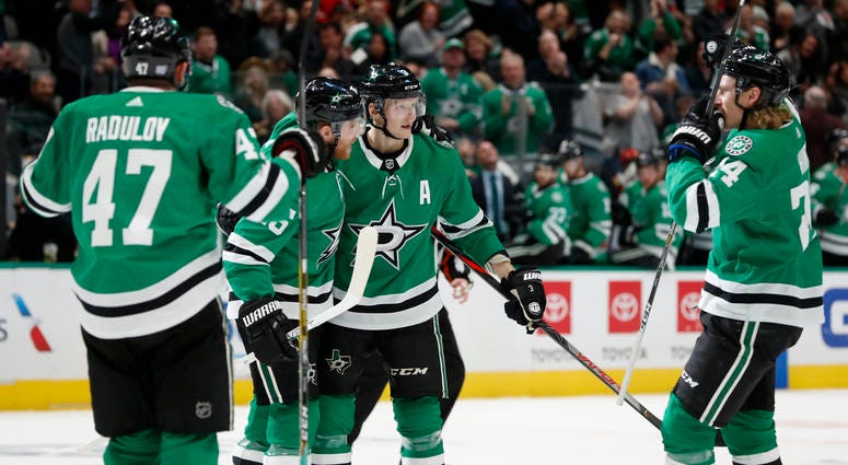 Dallas Stars' Blake Comeau, left, Mattias Janmark (13) and goaltender Anton Khudobin, right, celebrate after a shoot-out against the Chicago Blackhawks in an NHL hockey game in Dallas, Saturday, Nov. 23, 2019. The Stars won 2-1