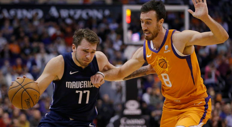 Luka Doncic drives the ball against the Suns