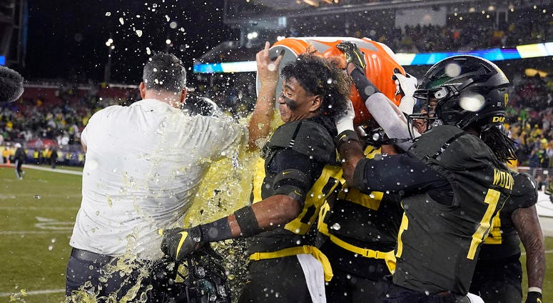 Oregon players douse coach Mario Cristobal near the end of the team's 37-15 win over Utah in an NCAA college football game for the Pac-12 Conference championship in Santa Clara, Calif., Friday, Dec. 6, 2018