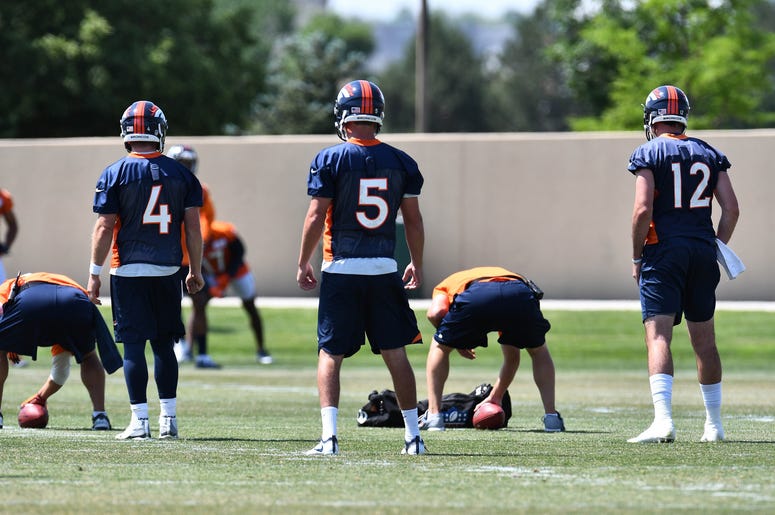 Jun 12, 2018; Englewood, CO, USA; Denver Broncos quarterback Case Keenum (4) and quarterback Nick Stevens (5) and quarterback Paxton Lynch (12) participate in drills during mini camp at the UCHealth Training Center. Mandatory Credit: Ron Chenoy-USA TODAY