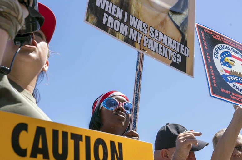 June 20, 2018; Phoenix, AZ, USA; Trump supports as both sides of the immigration debate yell at each other outside the McCain, Flake offices on 2200 block on Camelback Road in Phoenix. Mandatory Credit: Nick Oza/The Republic via USA TODAY NETWORK