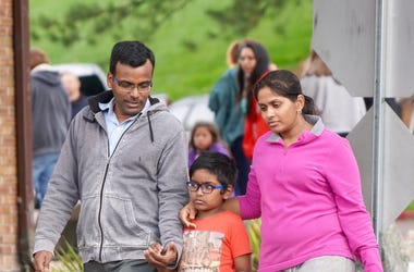 Bharani Rayana, 39, and Madhuri Adari, 32, hold tight to their second-grade son Daksha Rayana 8, following reunification at the Highlands Ranch Recreation Center after a school shooting. Colorado Stem School Shooting