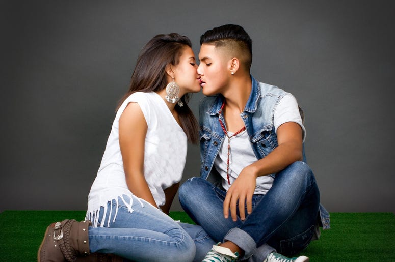 Couple kisses in a park