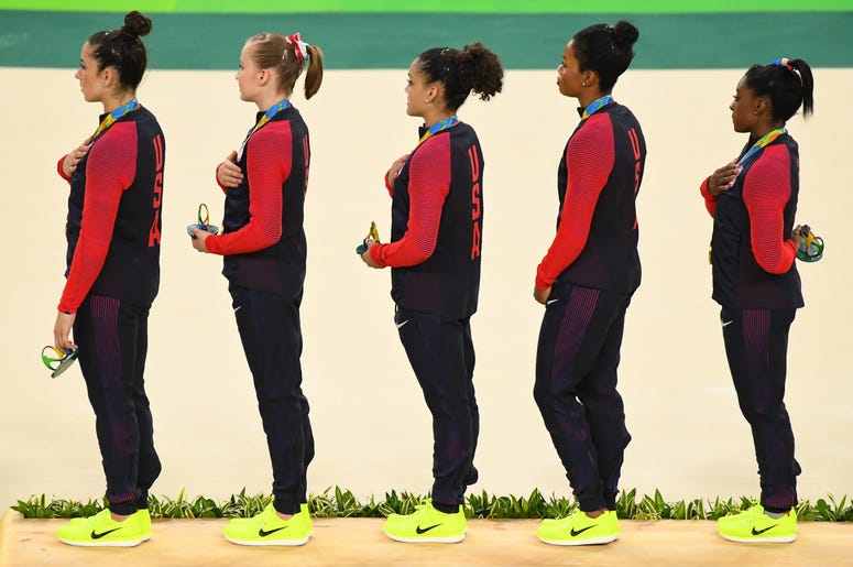 Aug 9, 2016; Rio de Janeiro, Brazil; Team USA wins gold on the podium during the women's team finals in the Rio 2016 Summer Olympic Games at Rio Olympic Arena. Mandatory Credit: Robert Deutsch-USA TODAY Sports