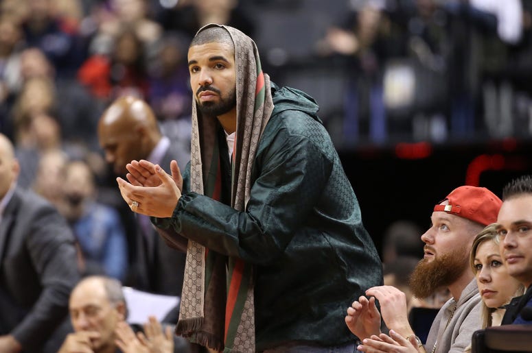 Rap artist Drake celebrates a basket by the Toronto Raptors against the Portland Trail Blazers at Air Canada Centre. The Raptors beat the Trail Blazers 117-115.