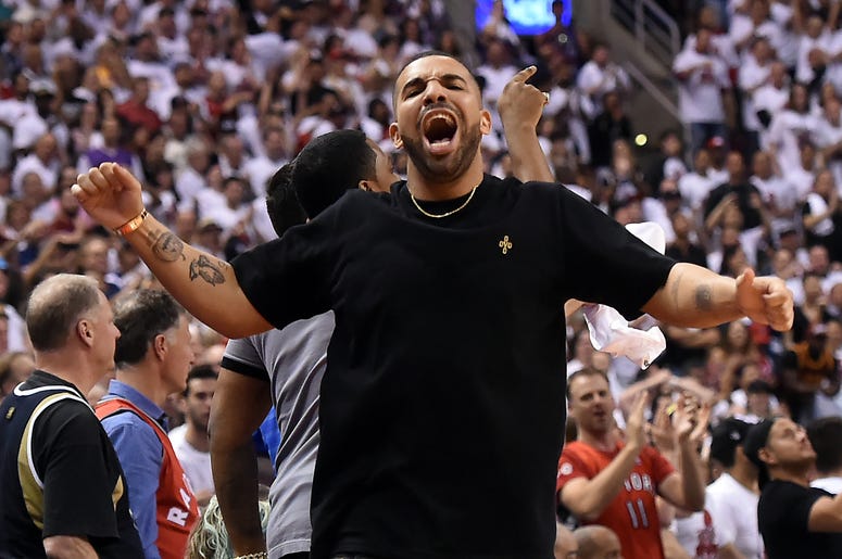May 23, 2016; Toronto, Ontario, CAN; Recording artist Drake celebrates after Toronto Raptors score a basket in a 105-99 win over Cleveland Cavaliers in game four of the Eastern conference finals of the NBA Playoffs at Air Canada Centre