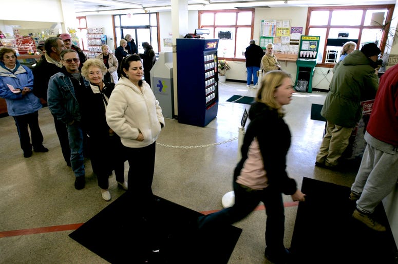 Customers line up to buys Mega Millions lottery tickets at the Penn-Ohio Medicine Mart in Masury, Ohio, on Tuesday, March 6, 2007. The Pennsylvania state line runs right through the store and customers can buy Mega Millions tickets on the Ohio portion of