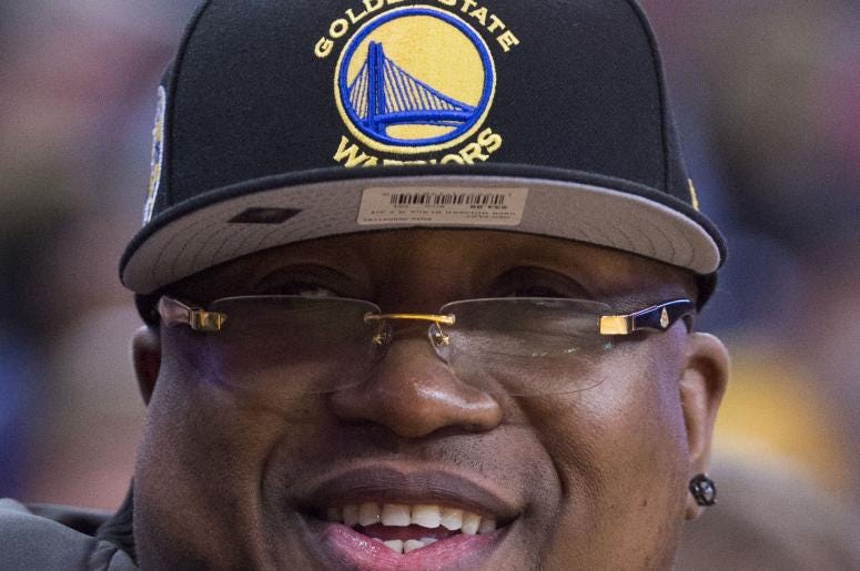 December 16, 2015; Oakland, CA, USA; Recording artist E-40 sits courtside during the second quarter between the Golden State Warriors and the Phoenix Suns at Oracle Arena. Mandatory Credit: Kyle Terada-USA TODAY Sports