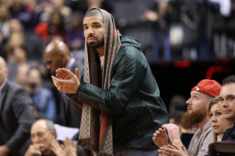 Rap artist Drake celebrates a basket by the Toronto Raptors against the Portland Trail Blazers at Air Canada Centre. The Raptors beat the Trail Blazers 117-115.