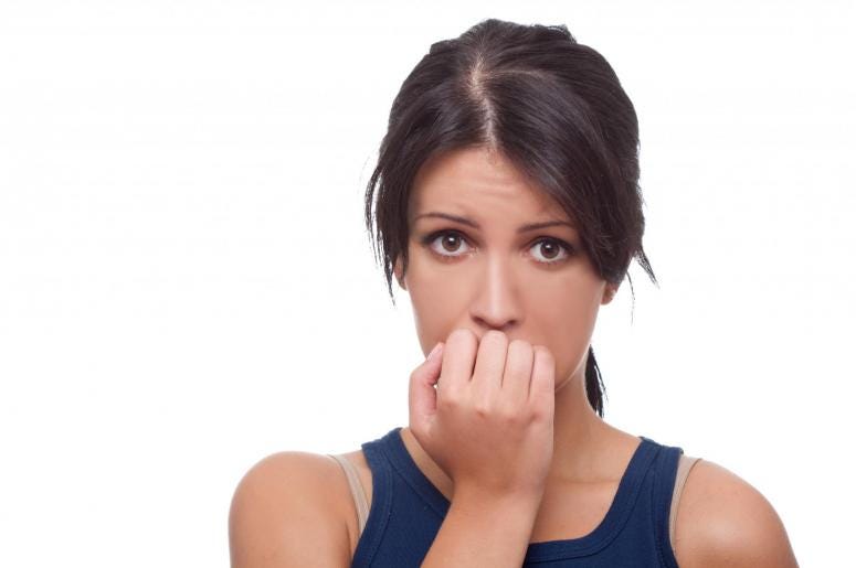 Head shot of worried woman over white background